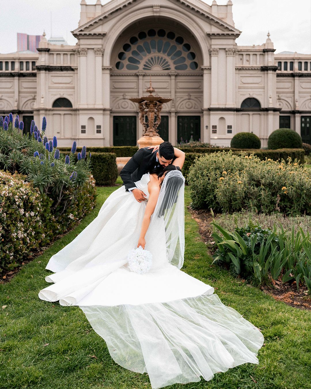A couple celebrating outside a grand Melbourne building