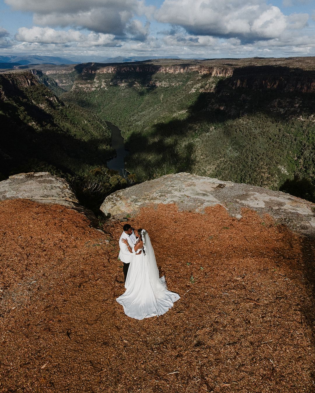 A couple together in a sweeping Australian landscape
